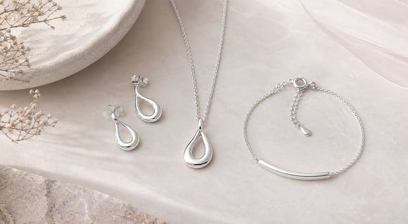 Coordinated sterling silver earrings, pendant and bracelet
